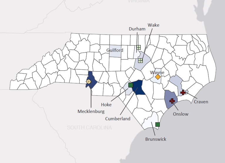 Map presenting top defense contract spending locations within the state of North Carolina with an overlay showing the positions of key military installations differentiated by service and active/reserve affiliation.