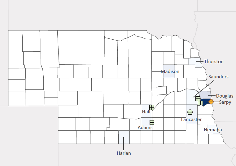 Map presenting top defense contract spending locations within the state of Nebraska with an overlay showing the positions of key military installations differentiated by service and active/reserve affiliation.