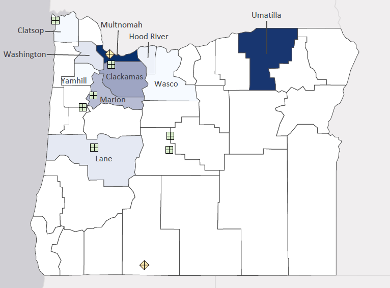 Map presenting top defense contract spending locations within the state of Oregon with an overlay showing the positions of key military installations differentiated by service and active/reserve affiliation.